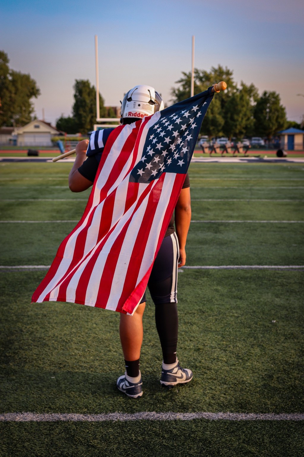 Football player carrying an American flag