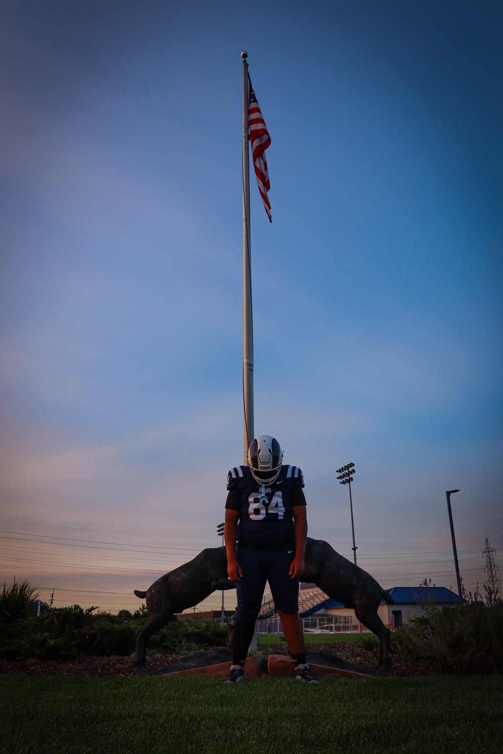 Football player portrait beneath a flagpole