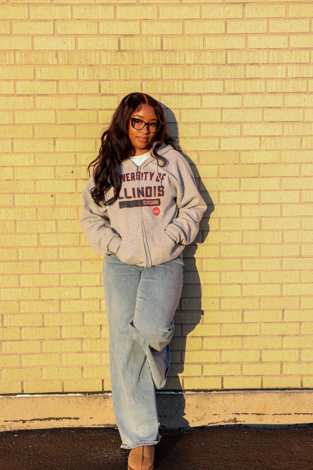 Standing portrait against a brick wall