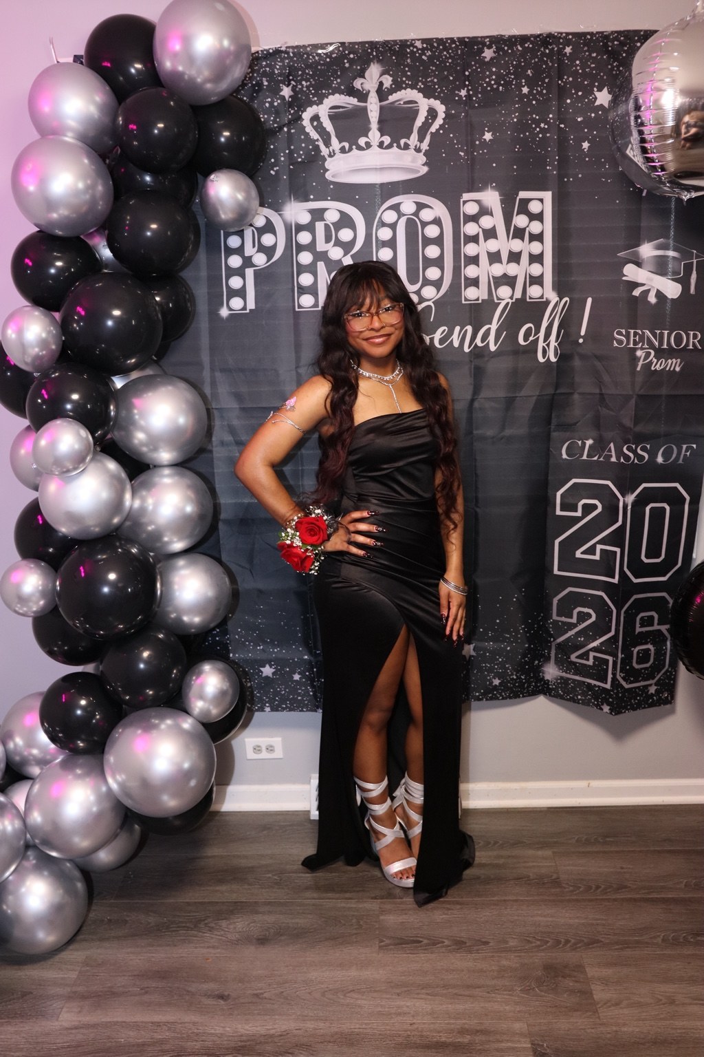 Prom portrait with black and silver balloons